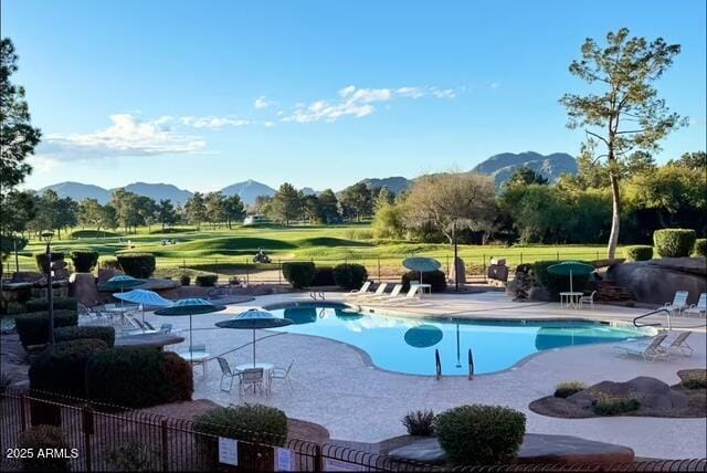 view of swimming pool featuring a mountain view and a patio area