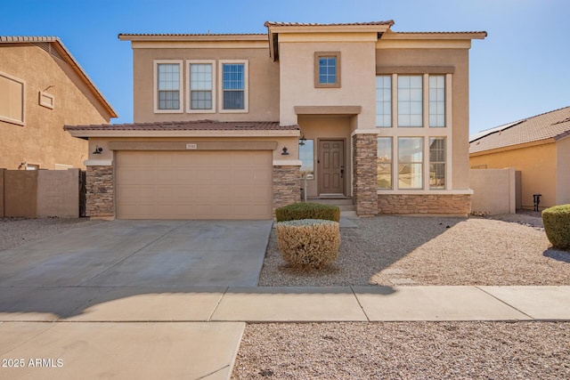 view of front of home featuring stone siding, concrete driveway, and stucco siding