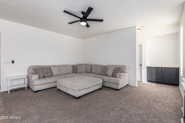 carpeted living area with a ceiling fan