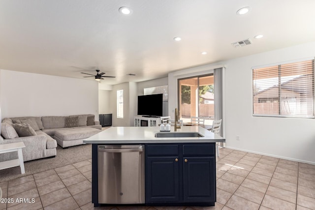 kitchen featuring a center island with sink, dishwasher, open floor plan, light countertops, and a sink