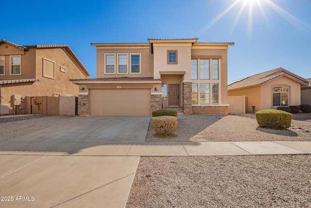 view of front of property with stucco siding, concrete driveway, a garage, stone siding, and a tiled roof