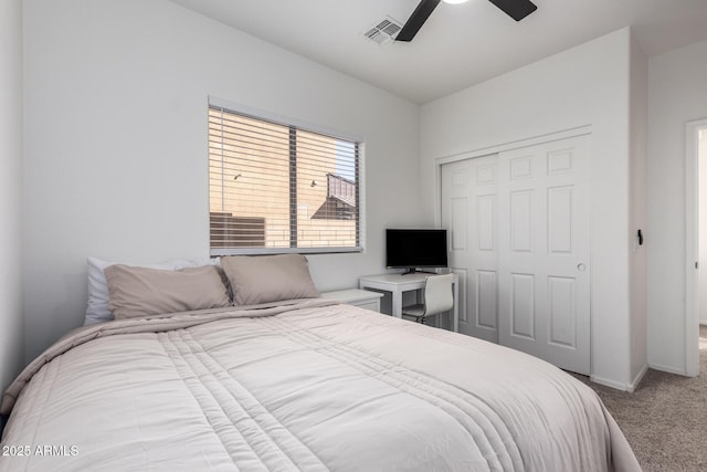 carpeted bedroom featuring a ceiling fan, baseboards, visible vents, and a closet