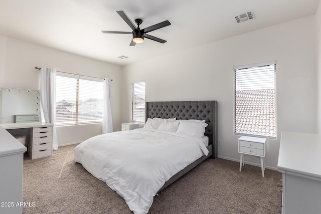 bedroom featuring carpet floors, baseboards, visible vents, and a ceiling fan