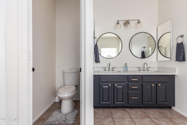 bathroom with tile patterned flooring, a sink, and double vanity