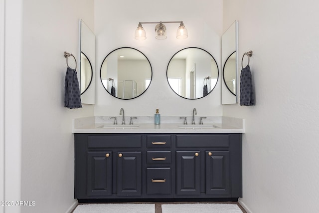 bathroom featuring a sink, baseboards, and double vanity