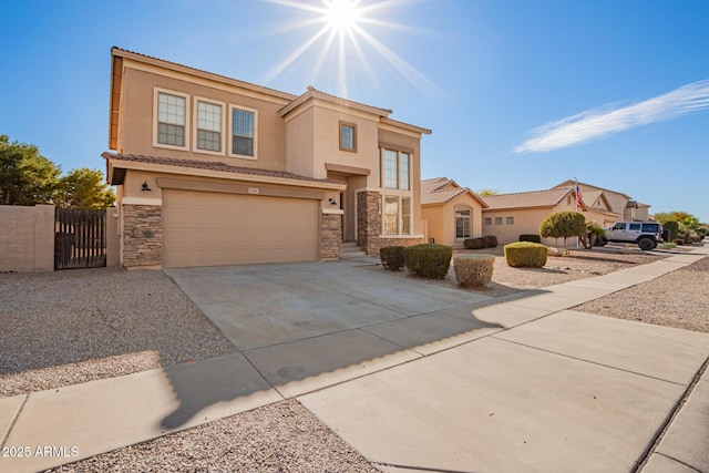 view of front of home with driveway, stone siding, an attached garage, and stucco siding