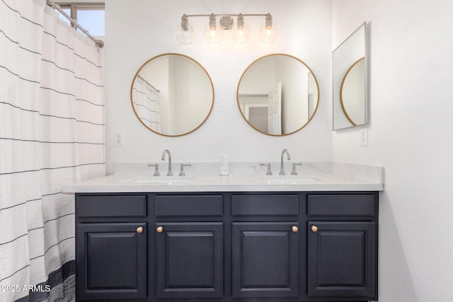 full bathroom featuring double vanity and a sink