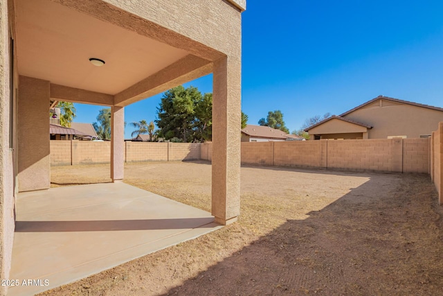 view of yard featuring a patio area and a fenced backyard