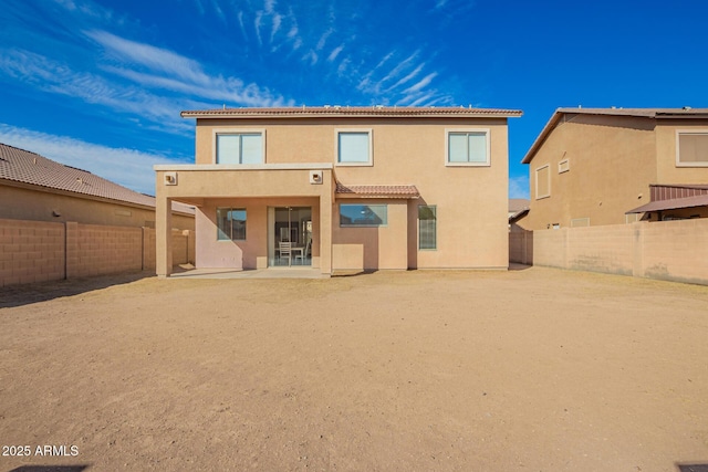 back of house with a patio area, a fenced backyard, and stucco siding