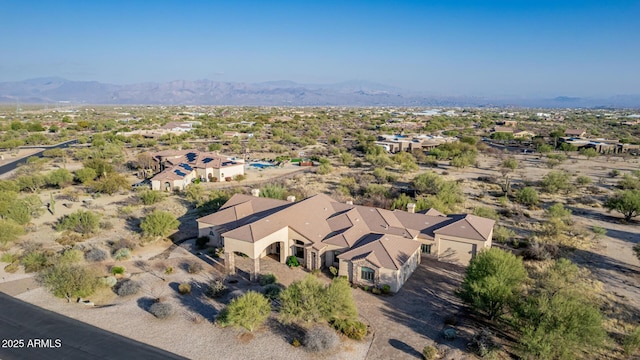 birds eye view of property with a mountain view