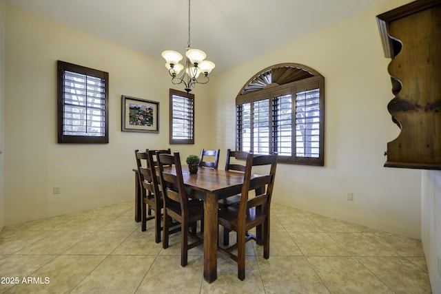 tiled dining space featuring a chandelier