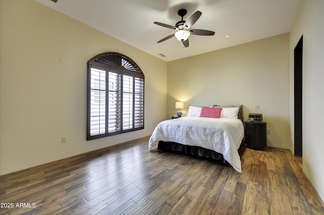 bedroom featuring ceiling fan and dark hardwood / wood-style floors