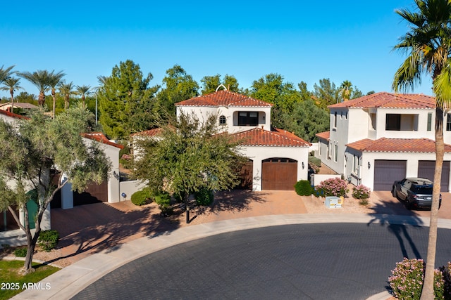 mediterranean / spanish house featuring a garage