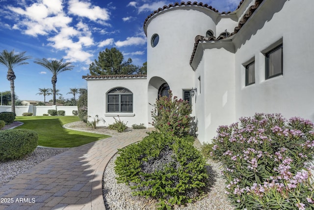 view of side of home featuring a yard