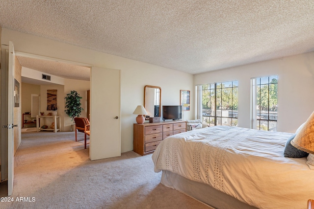 carpeted bedroom with a textured ceiling