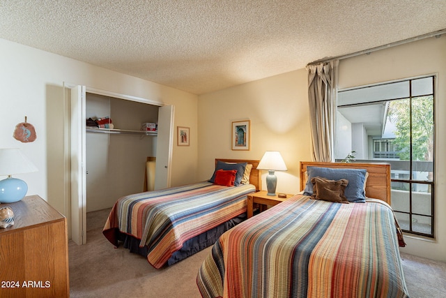 bedroom featuring a textured ceiling, a closet, and carpet floors