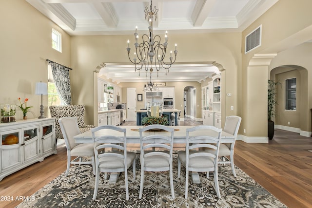 dining space featuring beam ceiling, wood-type flooring, and a wealth of natural light