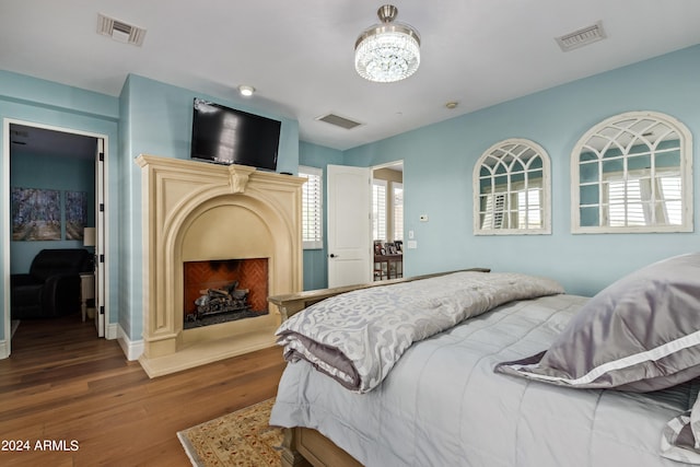 bedroom featuring a chandelier and wood-type flooring