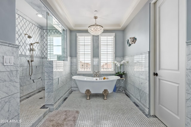 bathroom with tile patterned floors, tile walls, ornamental molding, a notable chandelier, and separate shower and tub