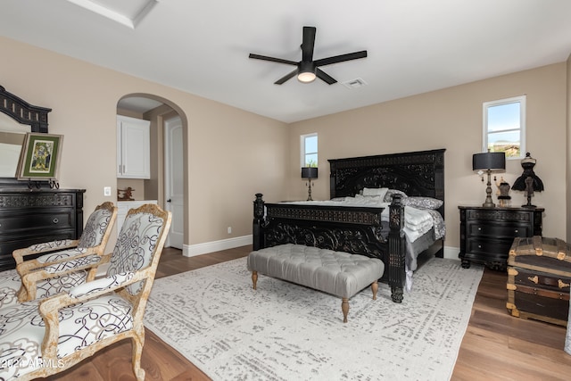 bedroom with ceiling fan, light hardwood / wood-style floors, and multiple windows