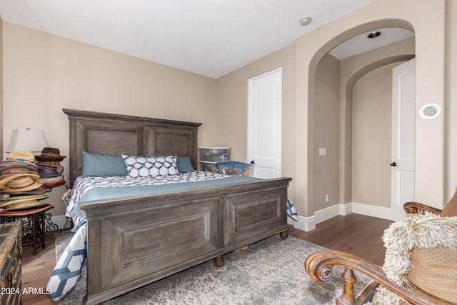 bedroom with dark wood-type flooring