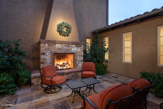 view of patio with an outdoor stone fireplace