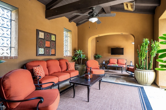 living room featuring ceiling fan, lofted ceiling with beams, and wooden ceiling