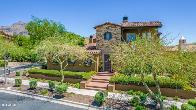 mediterranean / spanish home with a mountain view