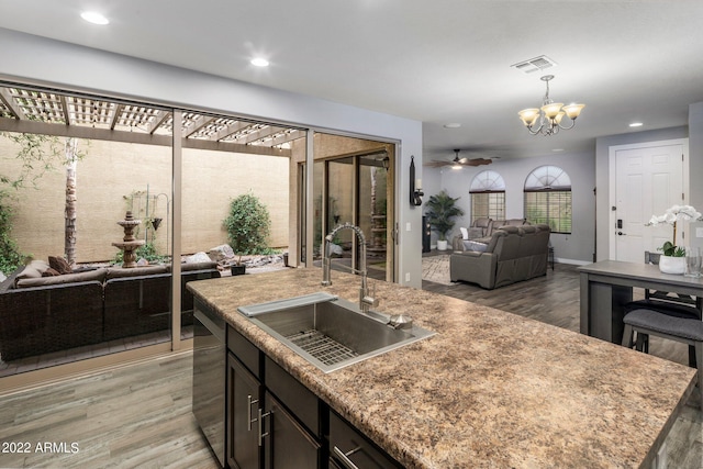 kitchen with a sink, visible vents, stainless steel dishwasher, and open floor plan