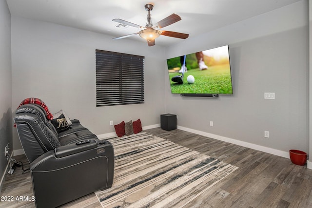 cinema with visible vents, ceiling fan, baseboards, and wood finished floors