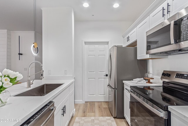 5401 E Van Buren St Unit 1088, Phoenix, AZ 85008 - kitchen with stainless steel appliances, light wood-style floors, white cabinetry, light stone counters, and recessed lighting