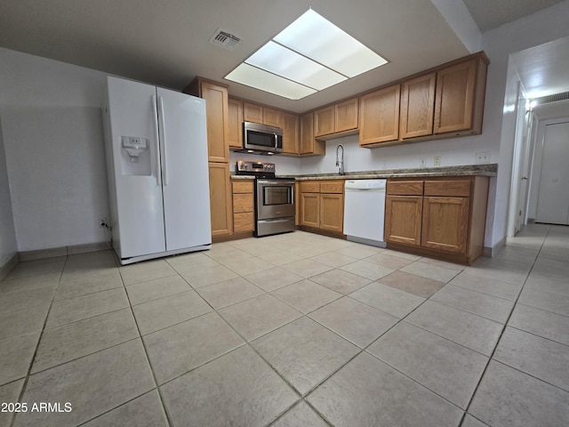 kitchen featuring light tile patterned floors, sink, and appliances with stainless steel finishes