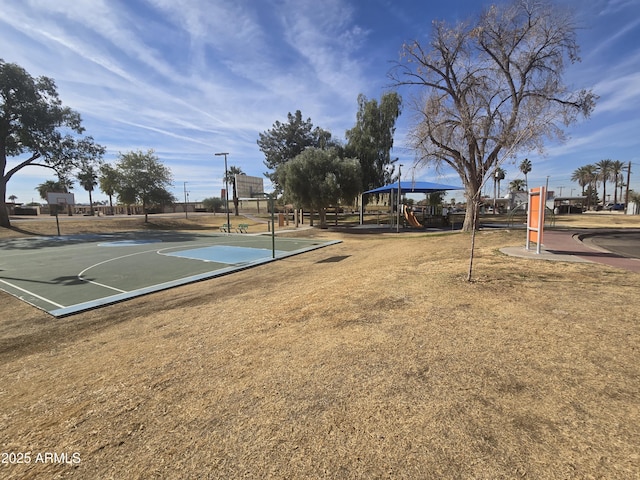 view of basketball court featuring a playground