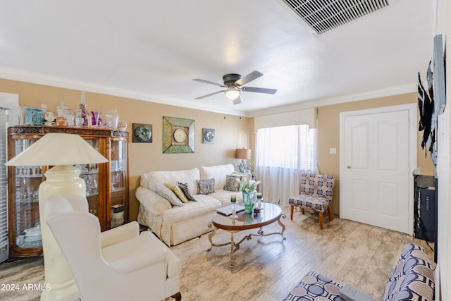 living room featuring ornamental molding, light hardwood / wood-style flooring, and ceiling fan