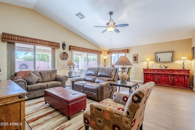 living room featuring ceiling fan, lofted ceiling, and light hardwood / wood-style flooring