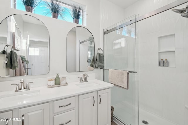 bathroom with vanity and a shower with shower door