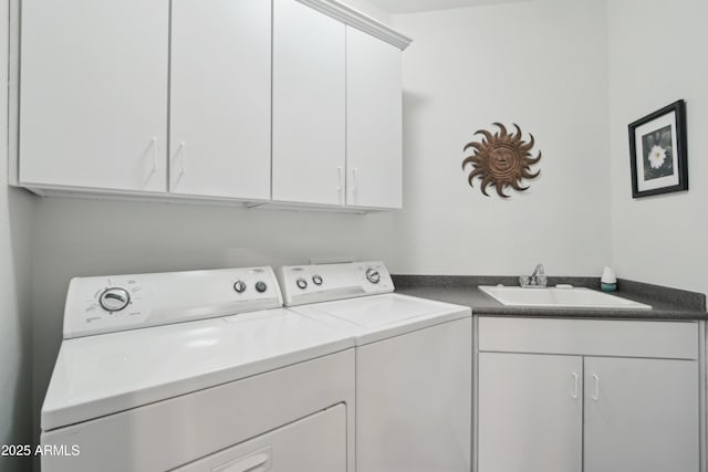 laundry room with cabinets, sink, and washing machine and clothes dryer