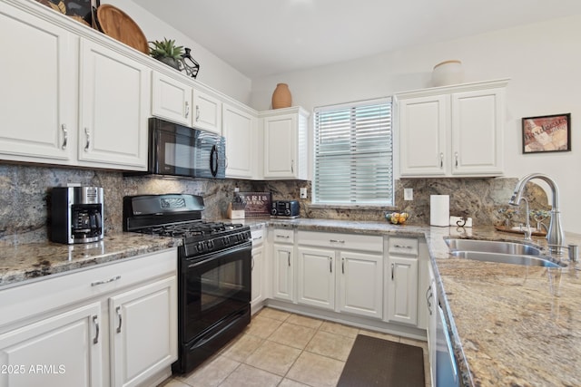 kitchen with tasteful backsplash, white cabinetry, sink, and black appliances