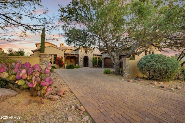 mediterranean / spanish home featuring a garage