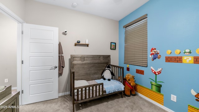 carpeted bedroom featuring baseboards