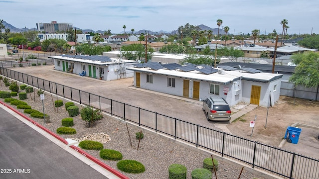 1620 E Palm Ln, Phoenix, AZ 85006 - view of front of house with a fenced backyard, solar panels, a residential view, and a mountain view