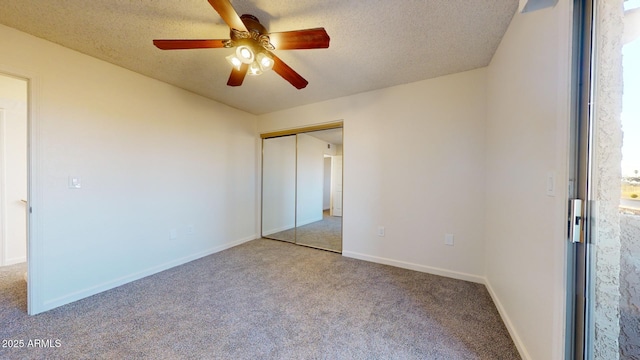 unfurnished bedroom featuring a closet, baseboards, a textured ceiling, and light colored carpet