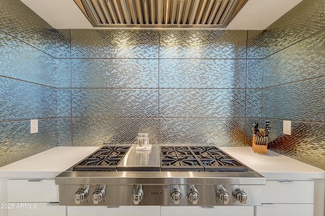 kitchen with decorative backsplash, stainless steel gas stovetop, and wall chimney range hood