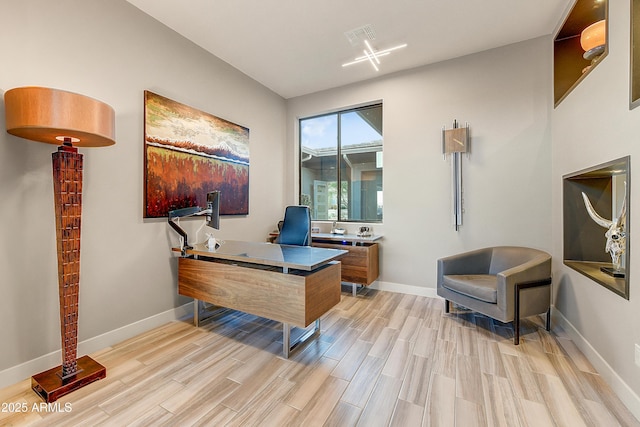 office with light wood-type flooring