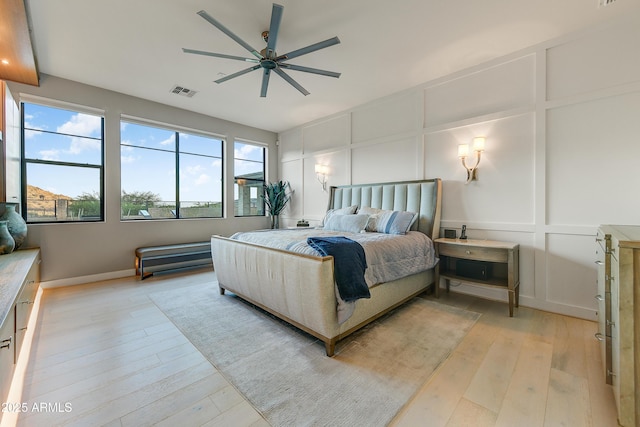 bedroom with light wood-type flooring and ceiling fan