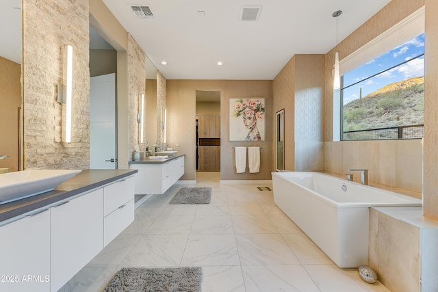 bathroom featuring a tub and vanity