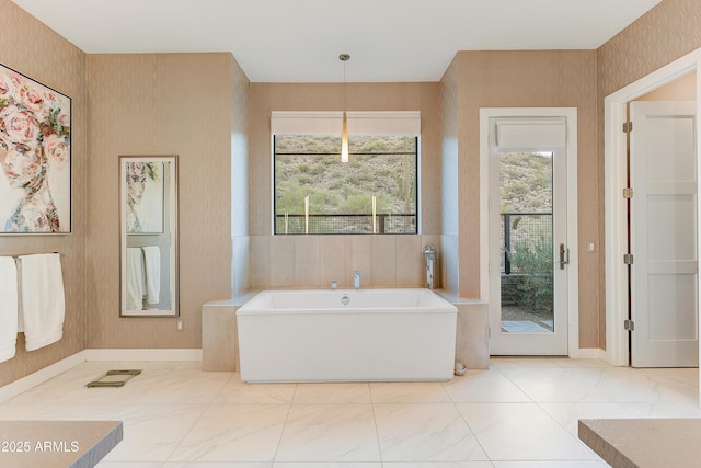 bathroom with a bath and plenty of natural light