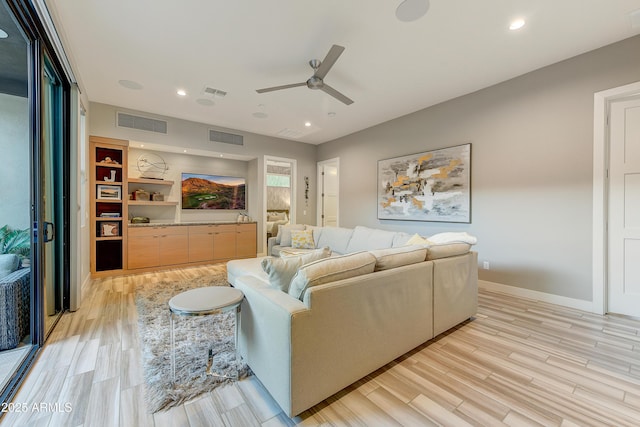 living room with ceiling fan and light wood-type flooring