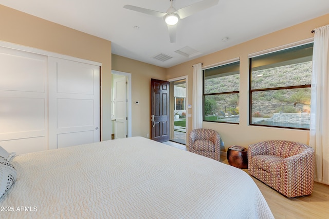 bedroom featuring light wood-type flooring, a closet, and ceiling fan