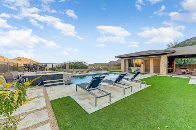 view of pool with a yard and a patio